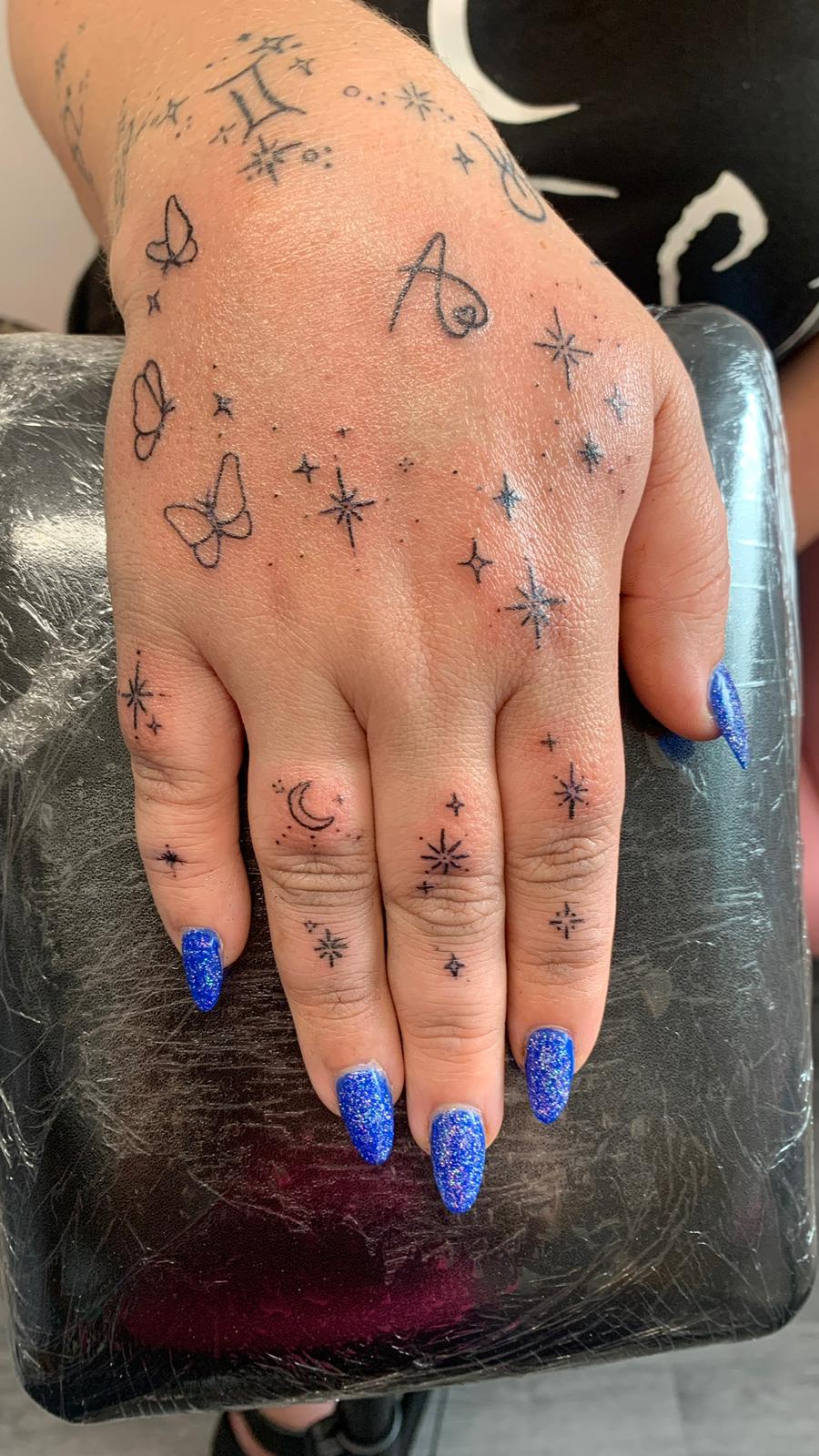 Tiny fine line flower tattoo by Ink By LOLO Merseyside Southport