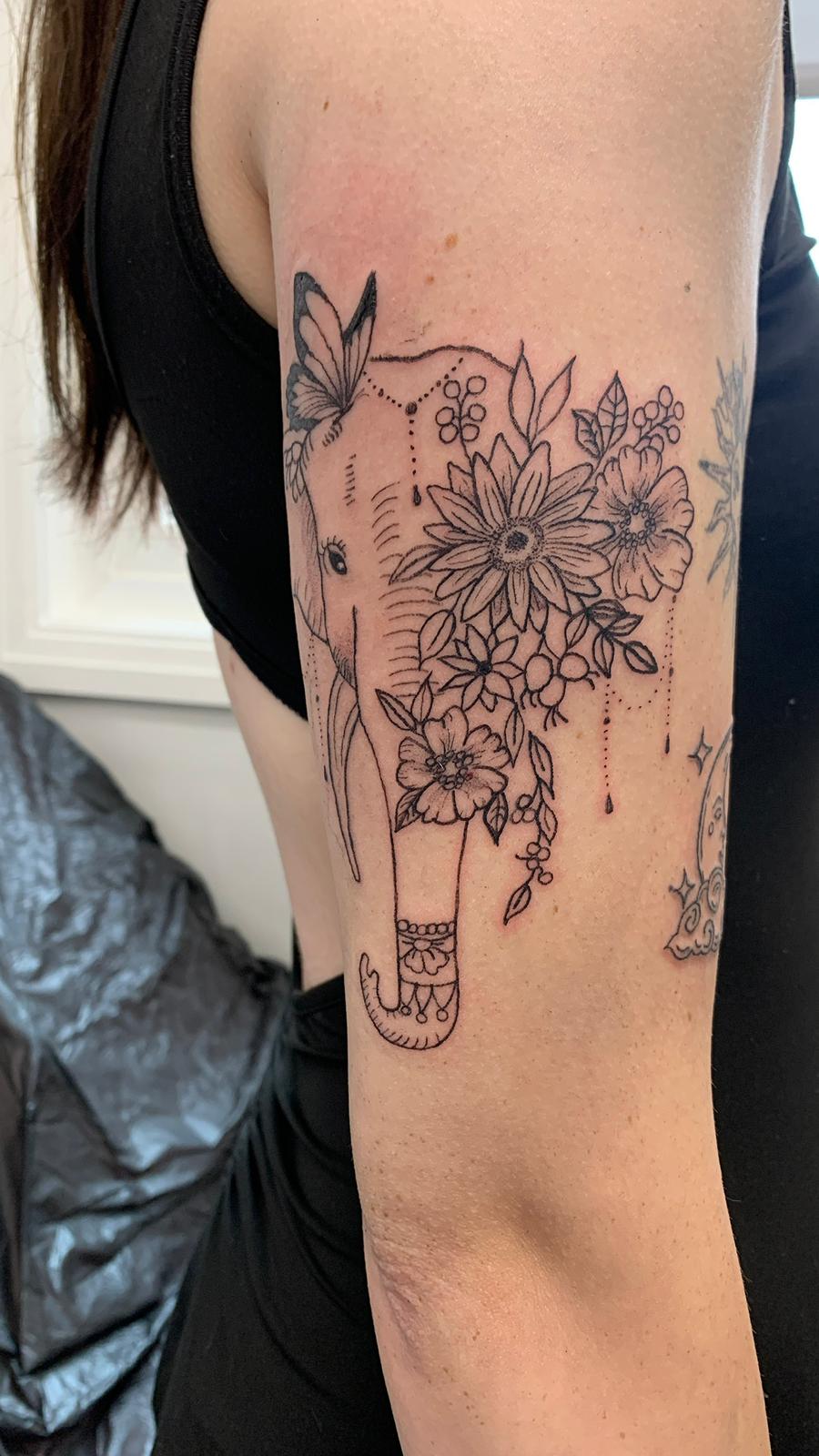 Delicate fine line symbol tattoo by Ink By LOLO Southport area